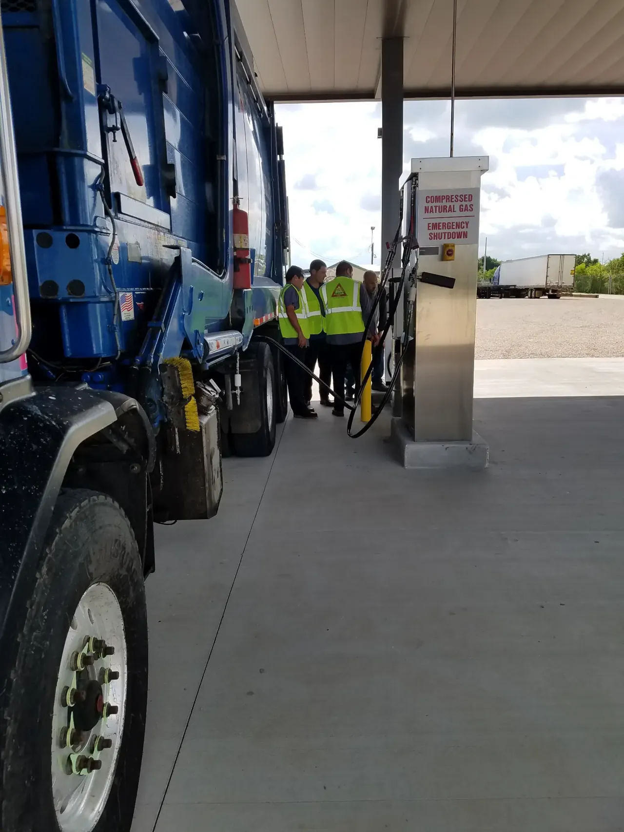 Commercial refuse truck beside a CNG dispenser at Almeda Fuels